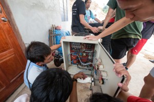 Students checking the electrical connections of the circuit board. 