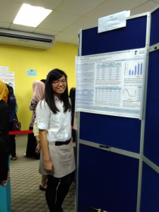 Tan Hui Woon with her poster detailing her findings.